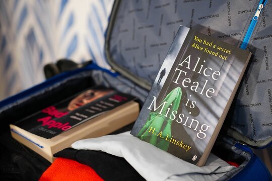 H. A. Linkey Alice Teale is Missing novel inside an open travel suitcase