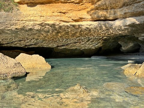 Beautiful sea rocks and cave grotto in paradise lagoon with clear water.