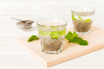 Healthy breakfast or morning with chia seeds and mint on table background, vegetarian food, diet and health concept. Chia pudding with and mint