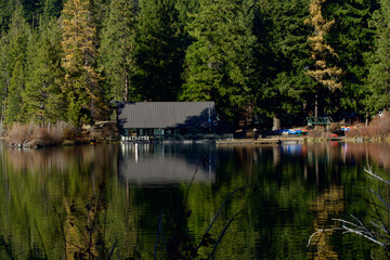 Suttle lake boat house reflecting on the water, Central Oregon 