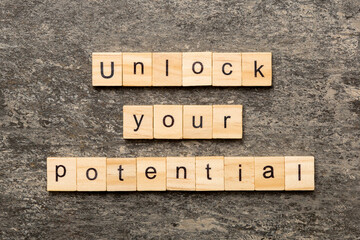 unlock your potential word written on wood block. unlock your potential text on table, concept