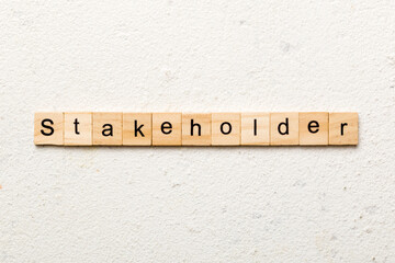 Stakeholder word written on wood block. Stakeholder text on cement table for your desing, concept