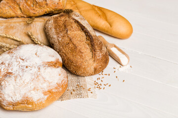 Homemade natural breads. Different kinds of fresh bread as background, perspective view with copy space