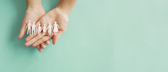 Fototapeta Hands holding multi generation family paper, family wellness, health insurance concept obraz