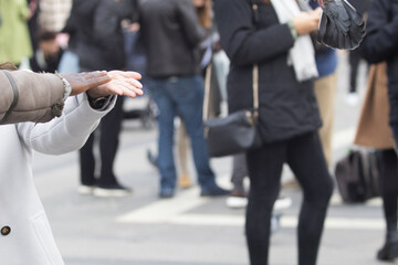 Two lovers dancing in the street and crossing their hands while smiling shyly in the crowd in the...