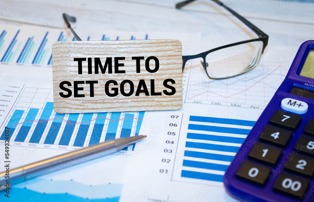 Poster time to set goals. two notepads with text on a white background next to a calculator
