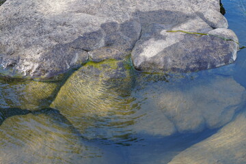Rocks on the bank of the river that have been eroded.