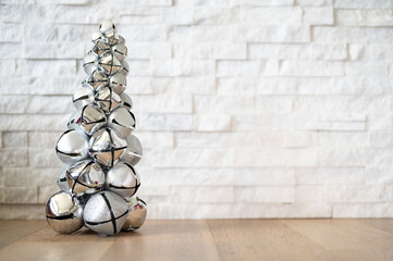 Christmas tree ornament on a white stone background with copyspace.