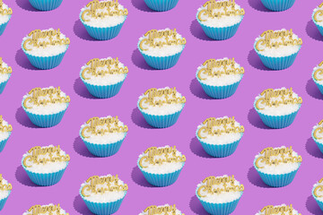Retro winter holidays pattern of pastel blue baking or cupcake cup with, ornaments, snow and Merry Christmas greetings on purple background. Vintage aesthetic Xmas concept.