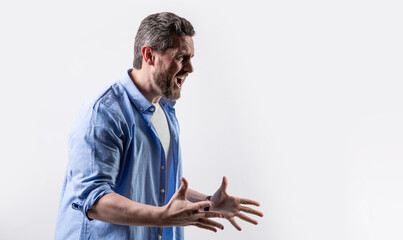 irritated man shouting with irritation isolated on grey background, copy space.