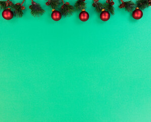 Merry Christmas and happy New Year background with fir tip branches plus red ball ornaments