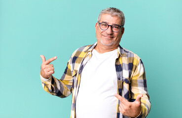 middle age senior man looking proud, arrogant, happy, surprised and satisfied, pointing to self,...