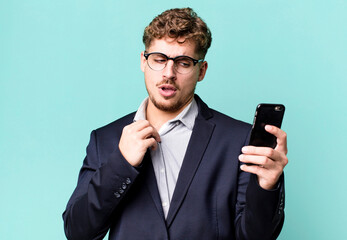 young adult caucasian businessman with a smartphone