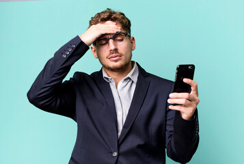 young adult caucasian businessman with a smartphone