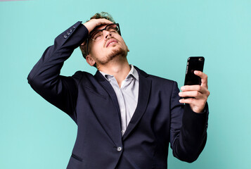 young adult caucasian businessman with a smartphone