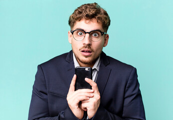 young adult caucasian businessman with a smartphone