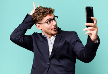 young adult caucasian businessman with a smartphone