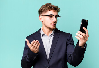 young adult caucasian businessman with a smartphone