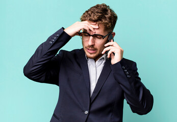 young adult caucasian businessman with a smartphone