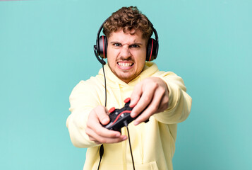 young adult caucasian man with headset and a controller. gamer concept © kues1