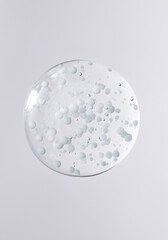 gel drop with white bubbles, cosmetic textures, skincare product smear, face serum, cream, oil, scrub, peeling