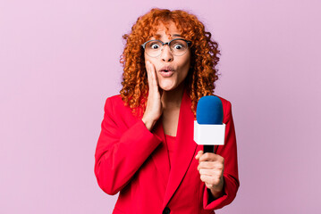 red hair pretty woman feeling shocked and scared. journalist and presenter concept
