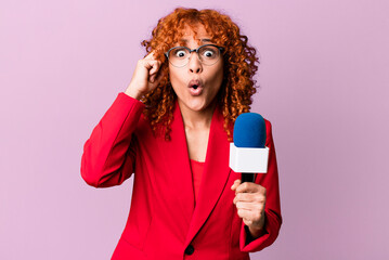 red hair pretty woman looking surprised, realizing a new thought, idea or concept. journalist and...