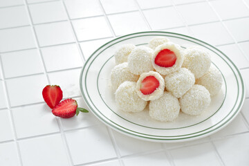 Lo mai chi, known in Mandarin as nuomici, is a glutinous sticky rice ball. Famous as a Chinese dessert, it taste sweet, soft and tough. With strawberry inside, dusted with dried coconut on the outside