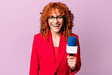 red hair pretty woman looking happy and pleasantly surprised. journalist and presenter concept