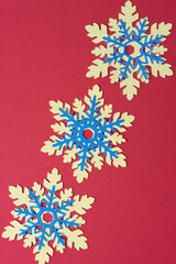 blue and yellow paper snowflakes on red