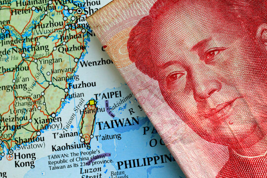 A yuan Chinese banknote on top of a map showing Taiwan