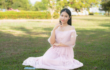 Wonderful day. Beautiful joyful long-haired young slim woman smiling and wearing a top and relaxing