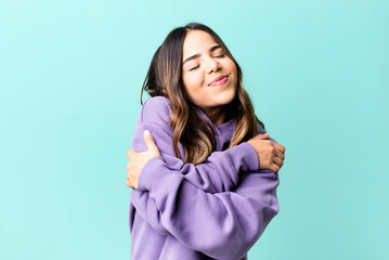hispanic pretty woman feeling in love, smiling, cuddling and hugging self, staying single, being...