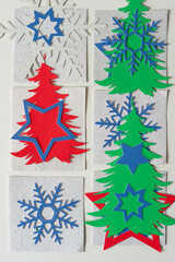 paper background with snowflakes and holiday tree shapes