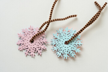 collection of paper snowflakes strung on pipe cleaners