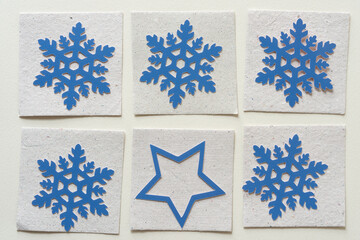 array of paper snowflakes and single star