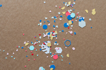 paper confetti scattered randomly on cardboard