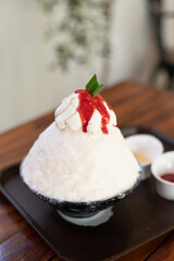Korean shaved ice dessert with sweet toppings, Strawberry Bingsu with soft focus