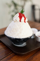 Korean shaved ice dessert with sweet toppings, Strawberry Bingsu with soft focus