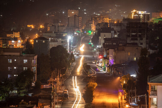 Low aerial night view of the city of Dessie, Ethiopia with traffic and street lights.