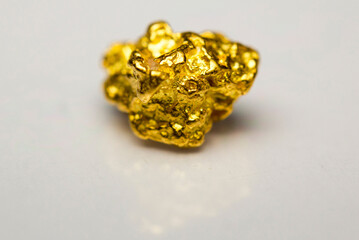 Close-up of a gold-nugget on a white background