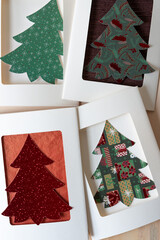 four retro paper cards with holiday tree cutouts