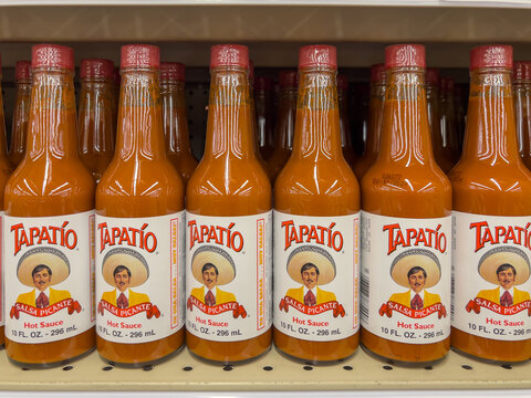 Pearland, TX, USA - March 15, 2022: Tapatio Salsa Picante hot sauce, 10 oz bottles on the shelf in a supermarket. 
