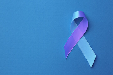 World Arthritis Day. Blue and purple awareness ribbon on color background, top view. Space for text