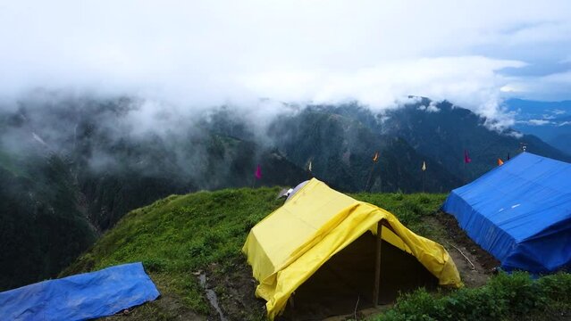 July 14th 2022, Himachal Pradesh India. Tents and camps with beautiful landscapes, valley and mountains in the background. Shrikhand Mahadev Kailash Yatra in the Himalayas.