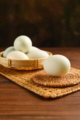 Close up colorful red yolk of salted duck eggs preserved in bamboo basket, asian style food