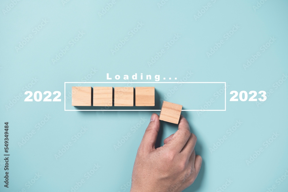 Poster businessman array wooden cube block with virtual loading bar for count down from 2022 to 2023 year o