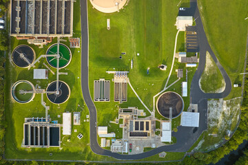 Aerial view of modern water cleaning facility at urban wastewater treatment plant. Purification process of removing undesirable chemicals, suspended solids and gases from contaminated liquid