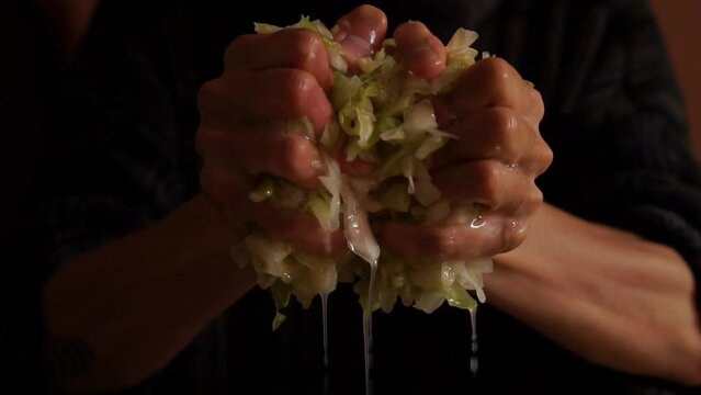 Horizontal video of a person squeezing cabbage.Food.