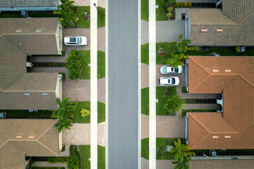 Aerial view of tightly located family houses in Florida closed suburban area. Real estate...